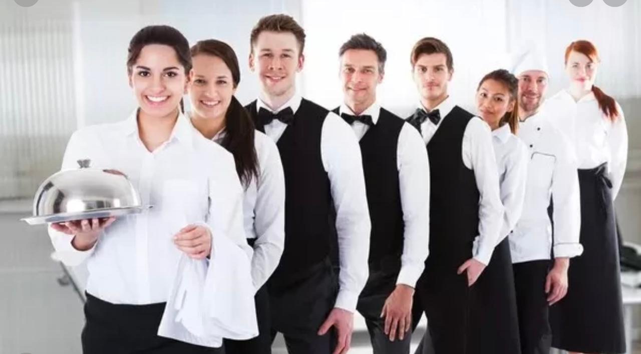 Lineup of waiters and chefs